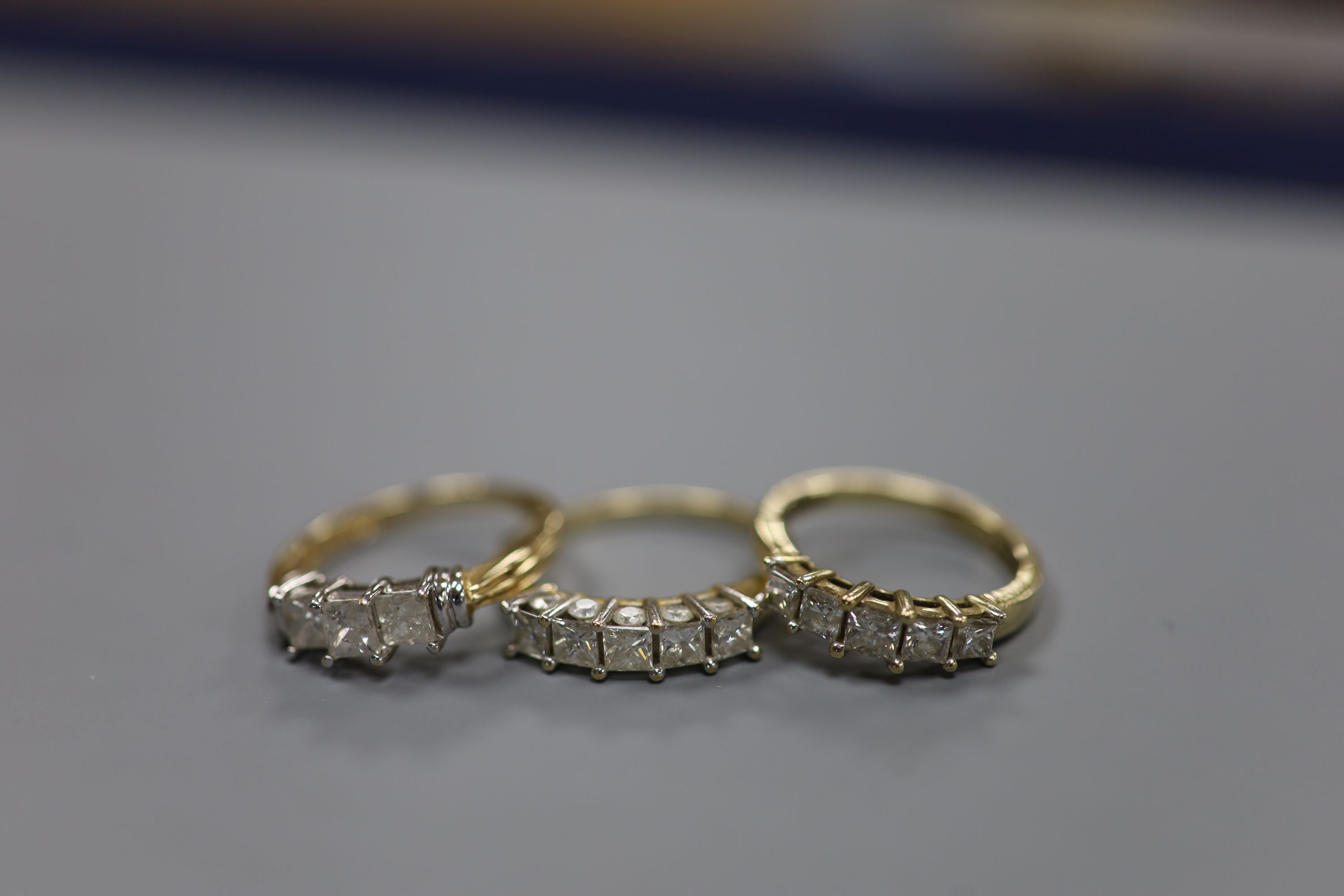 Two modern 9ct gold and five stone diamond set half hoop rings, sizes N & R/S gross 6.4 grams and a similar 14ct gold and three stone diamond ring, size P, gross 2.7 grams.